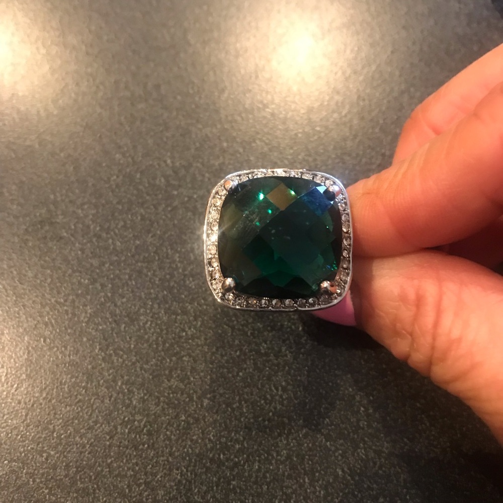 Cocktail ring emerald with CZ diamond around.